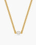 A gold choker against a white background